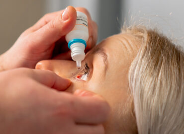 close-up in an ophthalmology clinic Freezing drops are put into a girl's eye